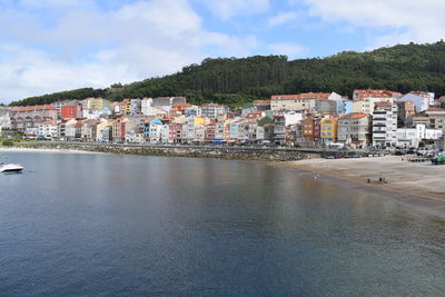 Town by sea against sky in city