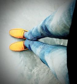 Low section of person wearing shoes standing on floor