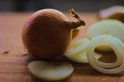 Close-up of onions on wooden table