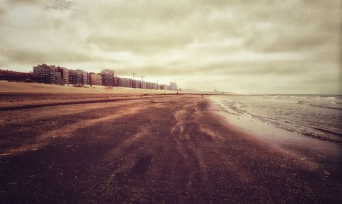 Scenic view of beach against sky in city