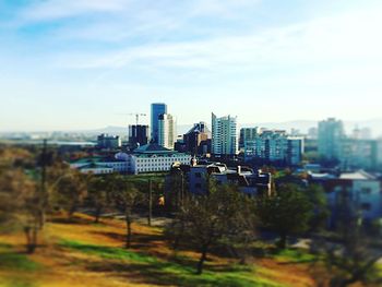 Tilt-shift image of city against sky