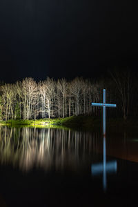 Scenic view of lake against sky at night