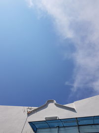 Low angle view of building against cloudy sky