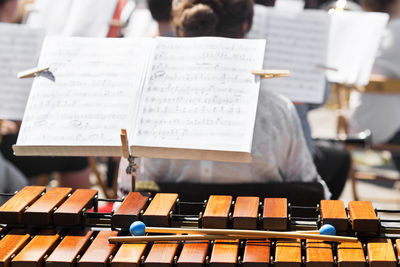 Close-up of musical equipment and sheet music in city