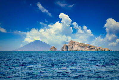 Panoramic view of sea against blue sky