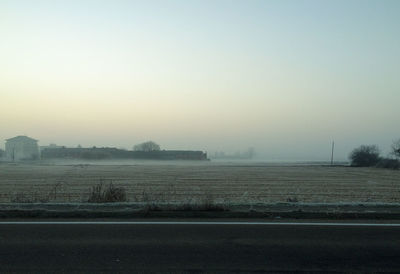 Scenic view of field against sky during foggy weather