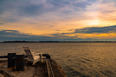 Pier on sea at sunset