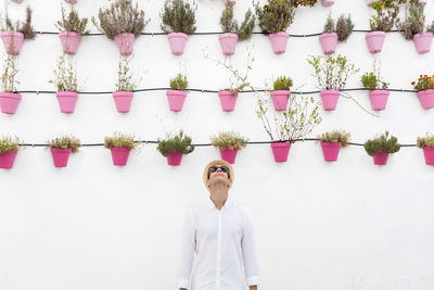 Man standing against white wall