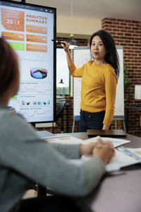 Portrait of smiling young woman working at office