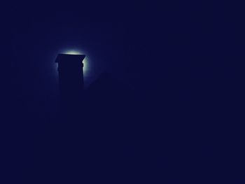 Low angle view of illuminated light against blue sky