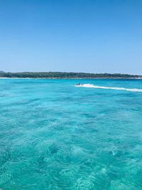 Scenic view of sea against clear blue sky