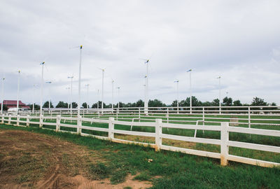 Fence on field against sky