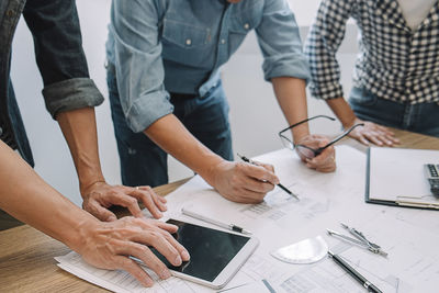 High angle view of people working on table