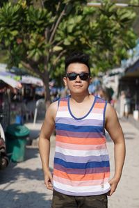 Portrait of man wearing sunglasses standing outdoors