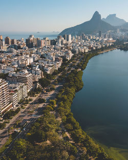 High angle view of buildings by sea against sky