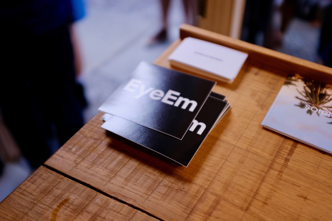 table, wood - material, indoors, focus on foreground, communication, close-up, real people, technology, day, freshness