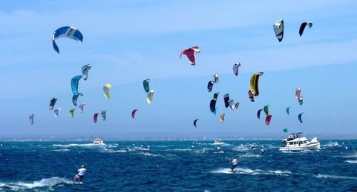 People kiteboarding in sea