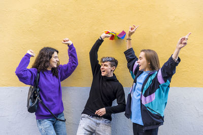 Young diverse friends talking outdoors on the street.