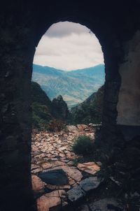 Scenic view of mountains against sky seen through arch