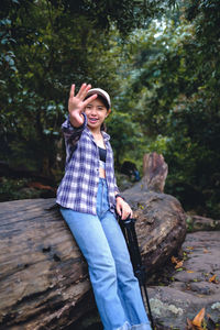 Portrait of young woman standing in forest