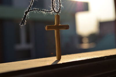 Close-up of cross on wood