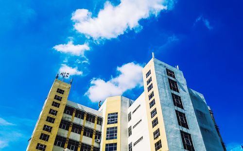 Low angle view of buildings against blue sky