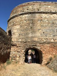 People in front of old ruin