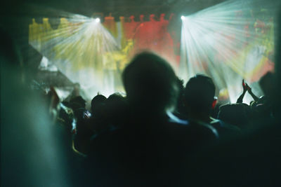 Rear view of silhouette people at music concert