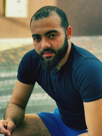 Portrait of young man sitting outdoors