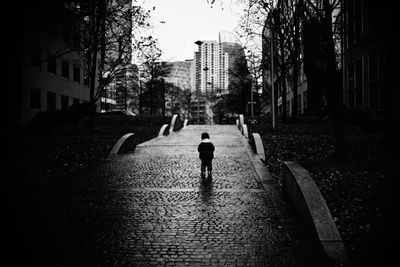 Rear view of man walking on street