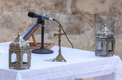 Close-up of lantern hanging on table at temple