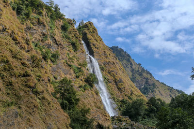 Low angle view of waterfall against sky