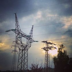 Low angle view of electricity pylon against sky