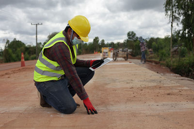 Rear view of man working at construction site