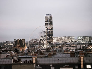 Buildings in city against clear sky