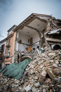 Low angle view of abandoned building against sky