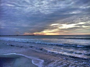 Scenic view of beach against sky during sunset