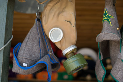 Low angle view of gas mask amidst headwear at store