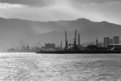 Commercial dock by sea against sky