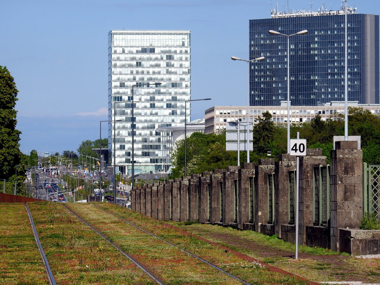 RAILROAD TRACKS AMIDST BUILDINGS AGAINST SKY