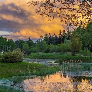 Scenic view of lake against cloudy sky