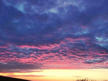 Low angle view of dramatic sky at sunset