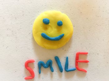 Close-up of smiley face on table