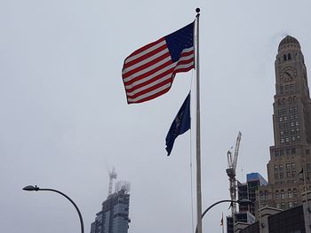 Low angle view of flags against clear sky