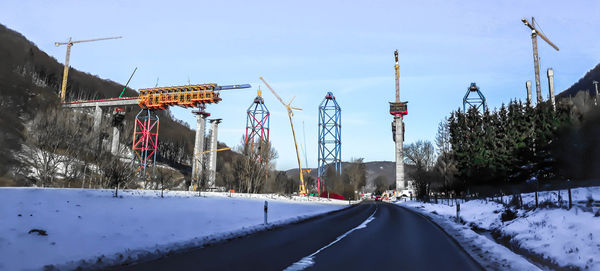 Panoramic view of snow covered road against sky