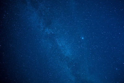 Low angle view of stars against blue sky at night