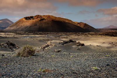 Scenic view of arid landscape against sky