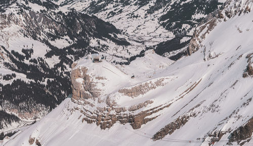 Snow covered landscape against mountain range