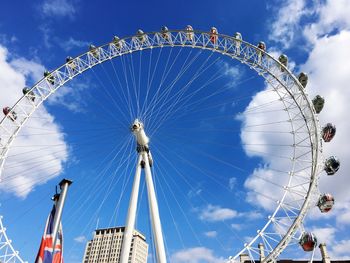 Low angle view of ferris wheel against blue sky