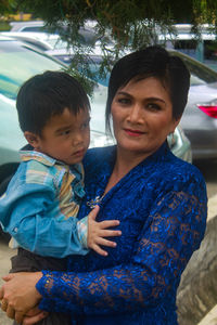 Portrait of mother with daughter in car